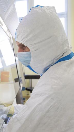 A man in protective equipment working with chemicals