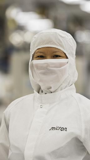 A woman in protective equipment looking at the camera