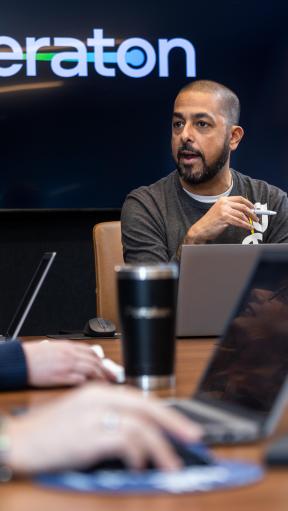 A man speaking with a woman in a business meeting