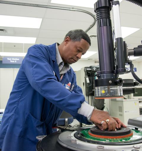 A man working on a device in a laboratory