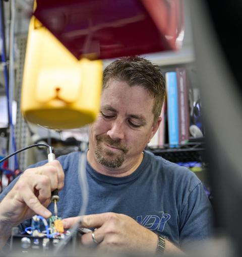 A man working on electronic equipment