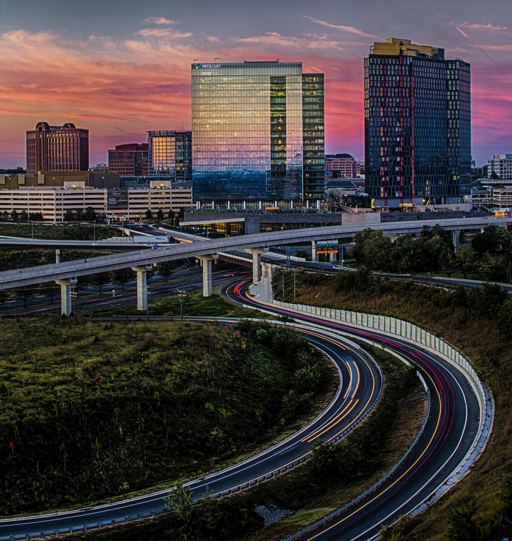 A picture of an urban skyline behind an interstate