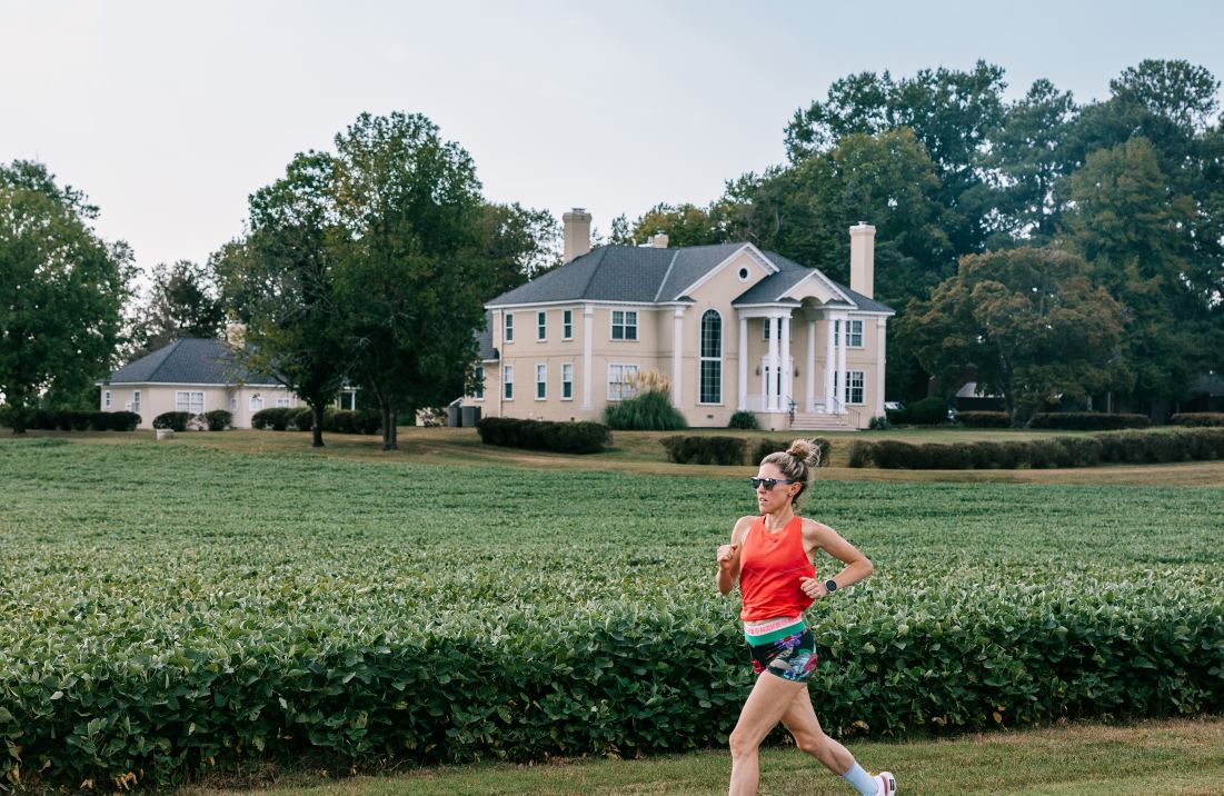 Girl running across Virginia Capital Trail