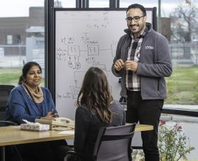 Sunta Dodani, M.D., Ph.D., left, meets with staff of the EVMS-Sentara Healthcare Analytics and Delivery Science Institute (HADSI)