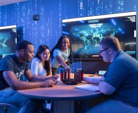 4 ODU School of Cybersecurity Students sitting around a table