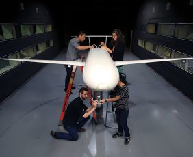 Four people working on a plane to support the NASA Langley partnership